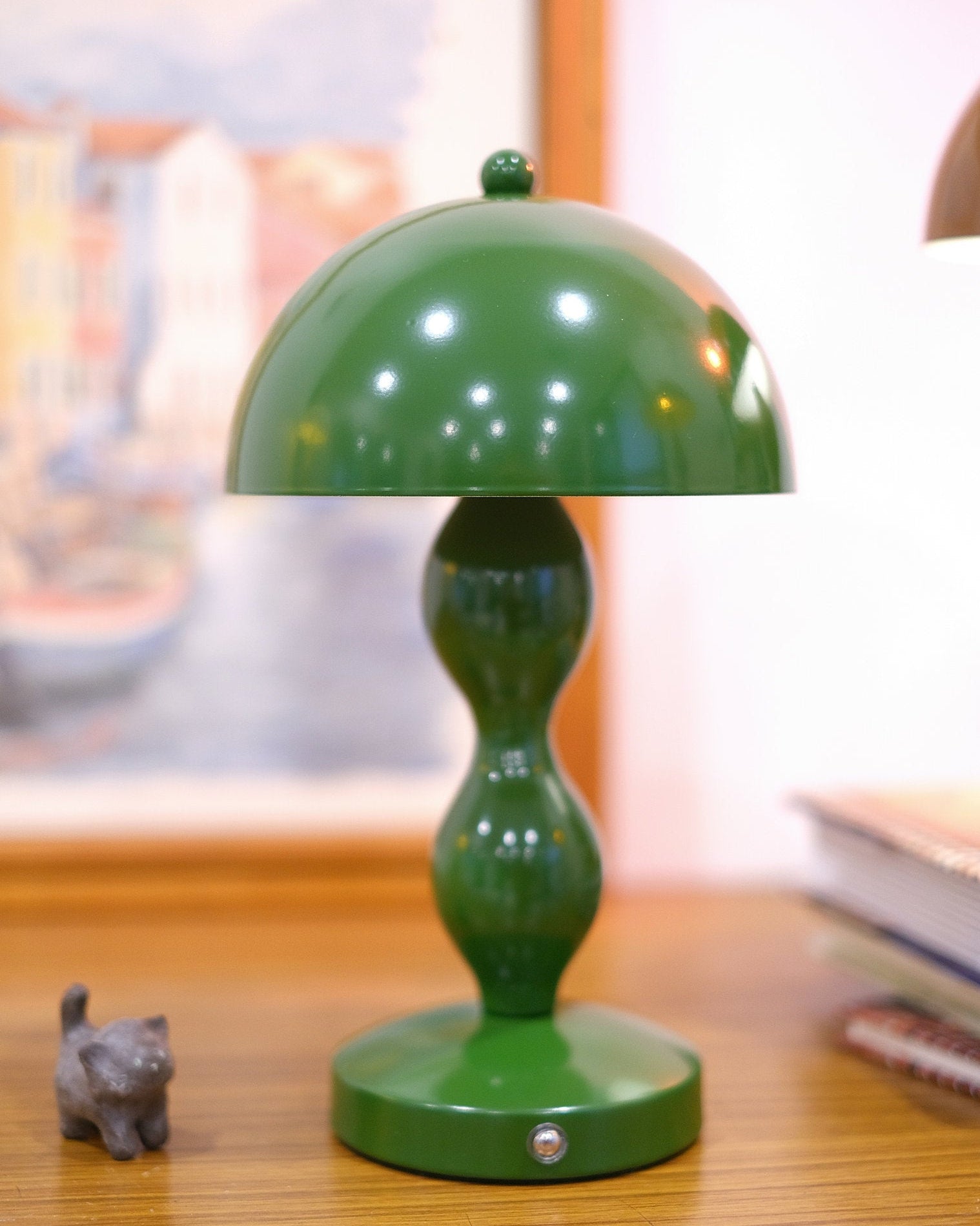 Dori LED lamp close-up showing touch switch base on a wooden surface with a blurred background