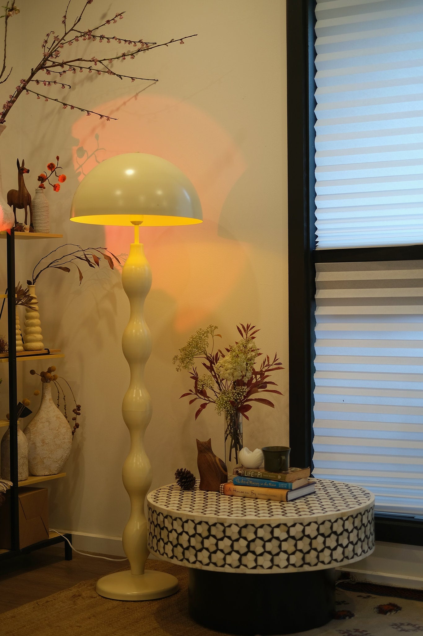 Room interior with Funky butter yellow mushroom lamp styled in a modern living room, small table, and decorative items.