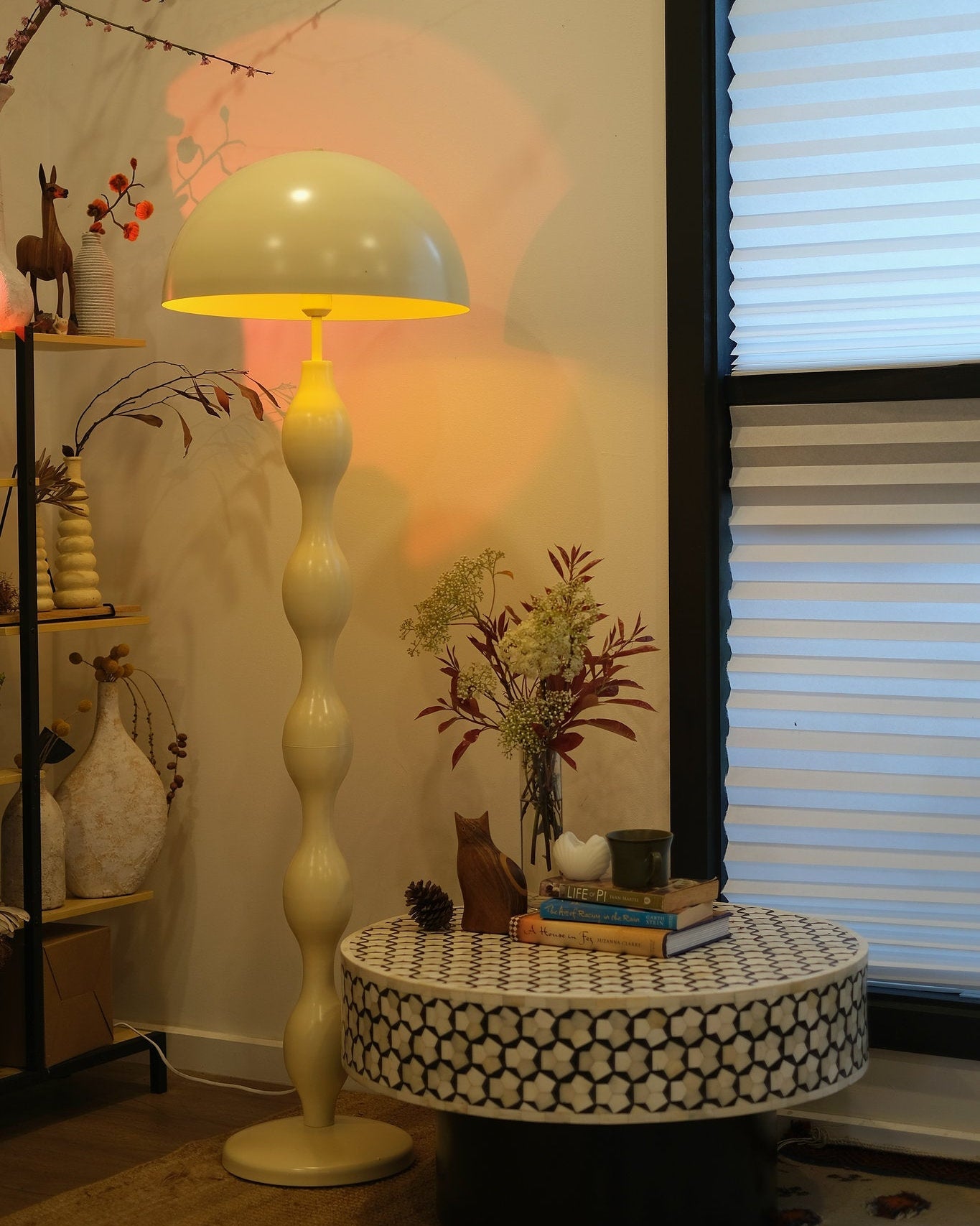 Room interior with Funky butter yellow mushroom lamp styled in a modern living room, small table, and decorative items.
