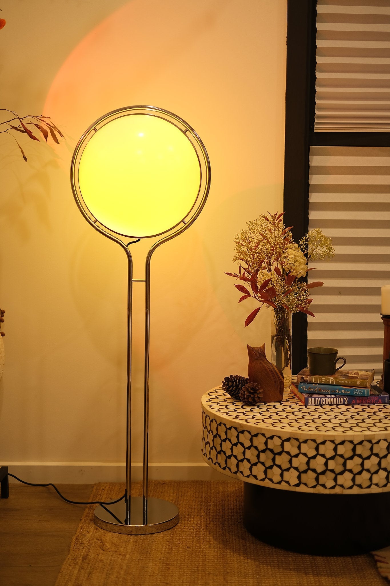 Garreau Globe Floor Lamp Bauhaus Replica Chrome Stand with a round yellow light shade in a room setting.