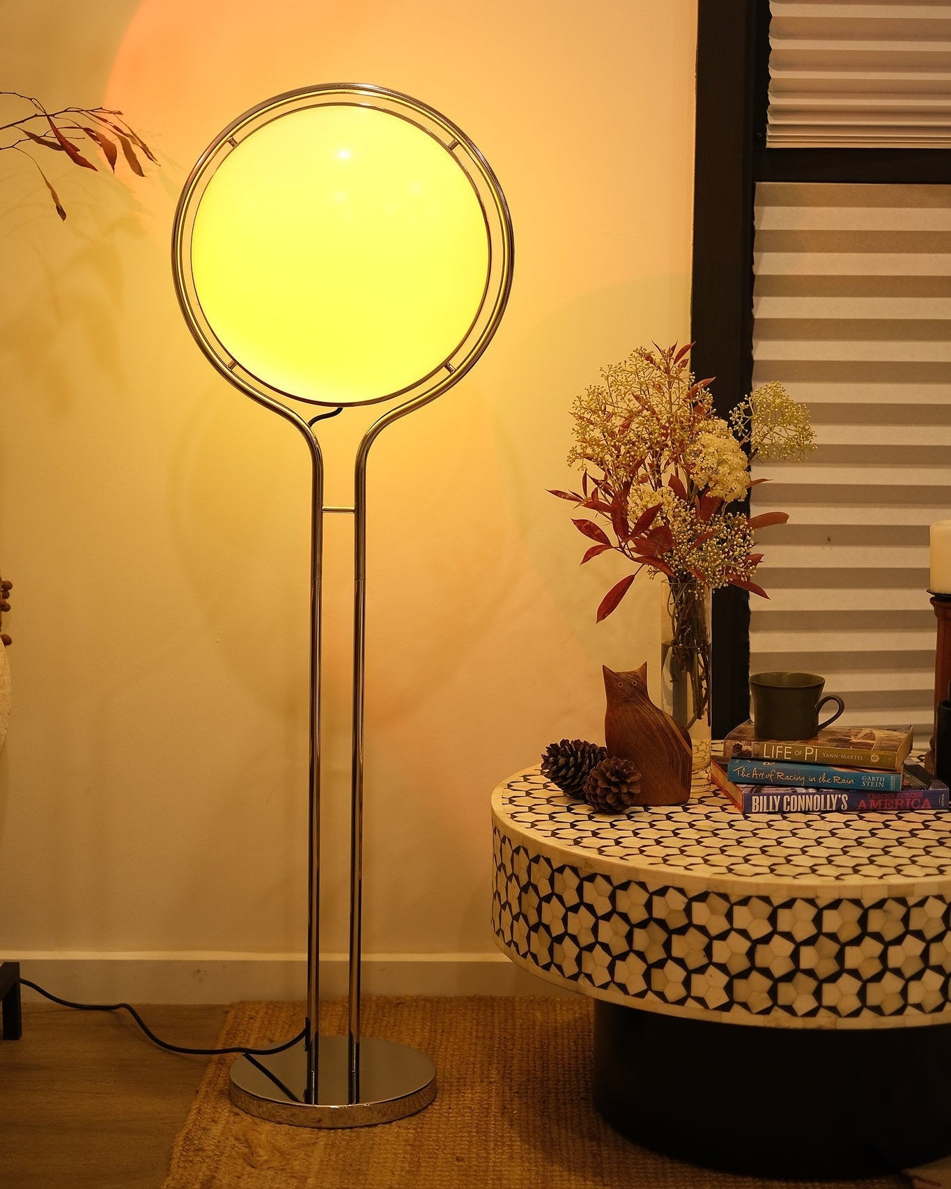Garreau Globe Floor Lamp Bauhaus Replica Chrome Stand with a round yellow light shade in a room setting.