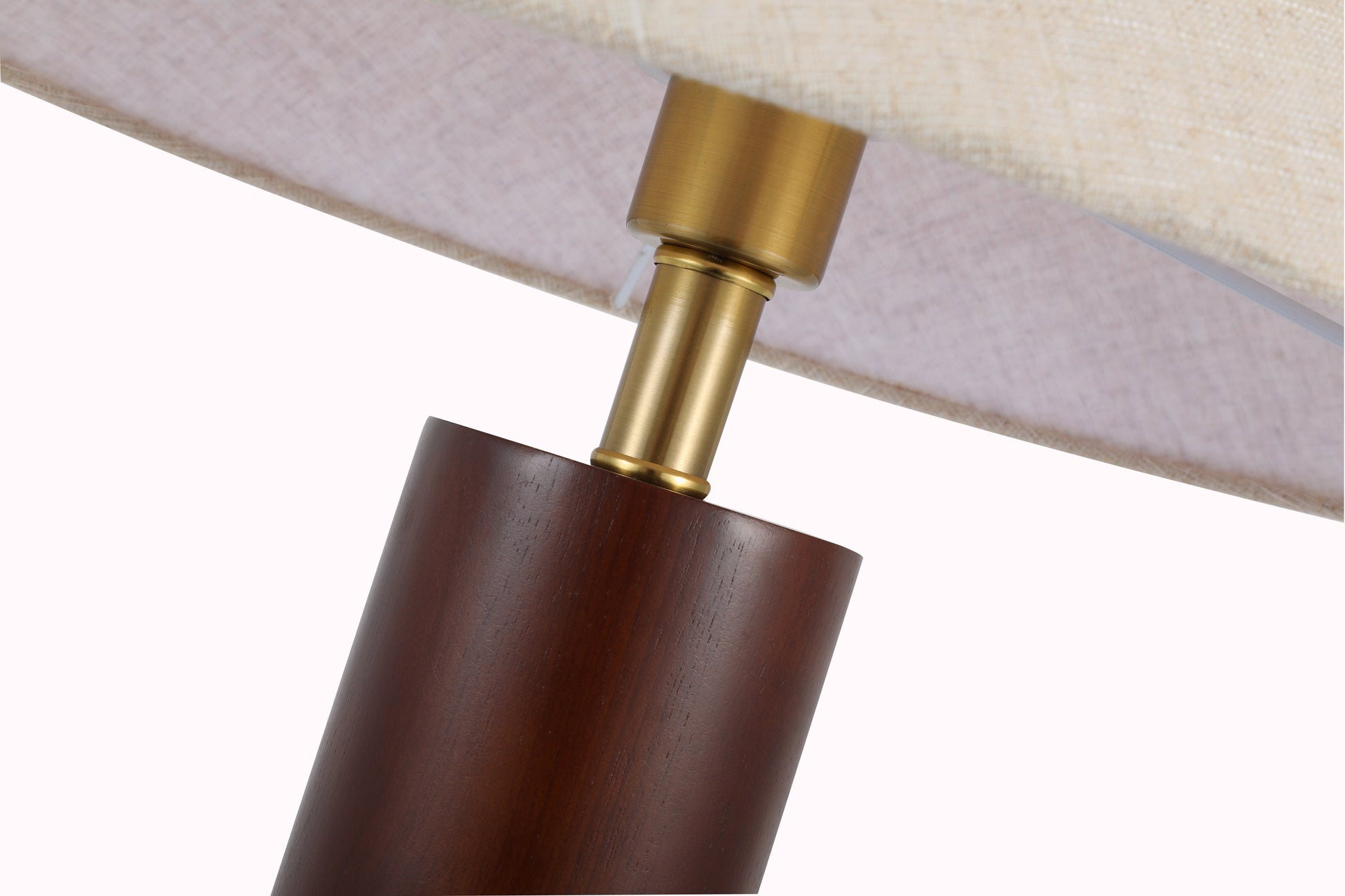 Close-up of a lamp with wooden base and brass fitting on a white background