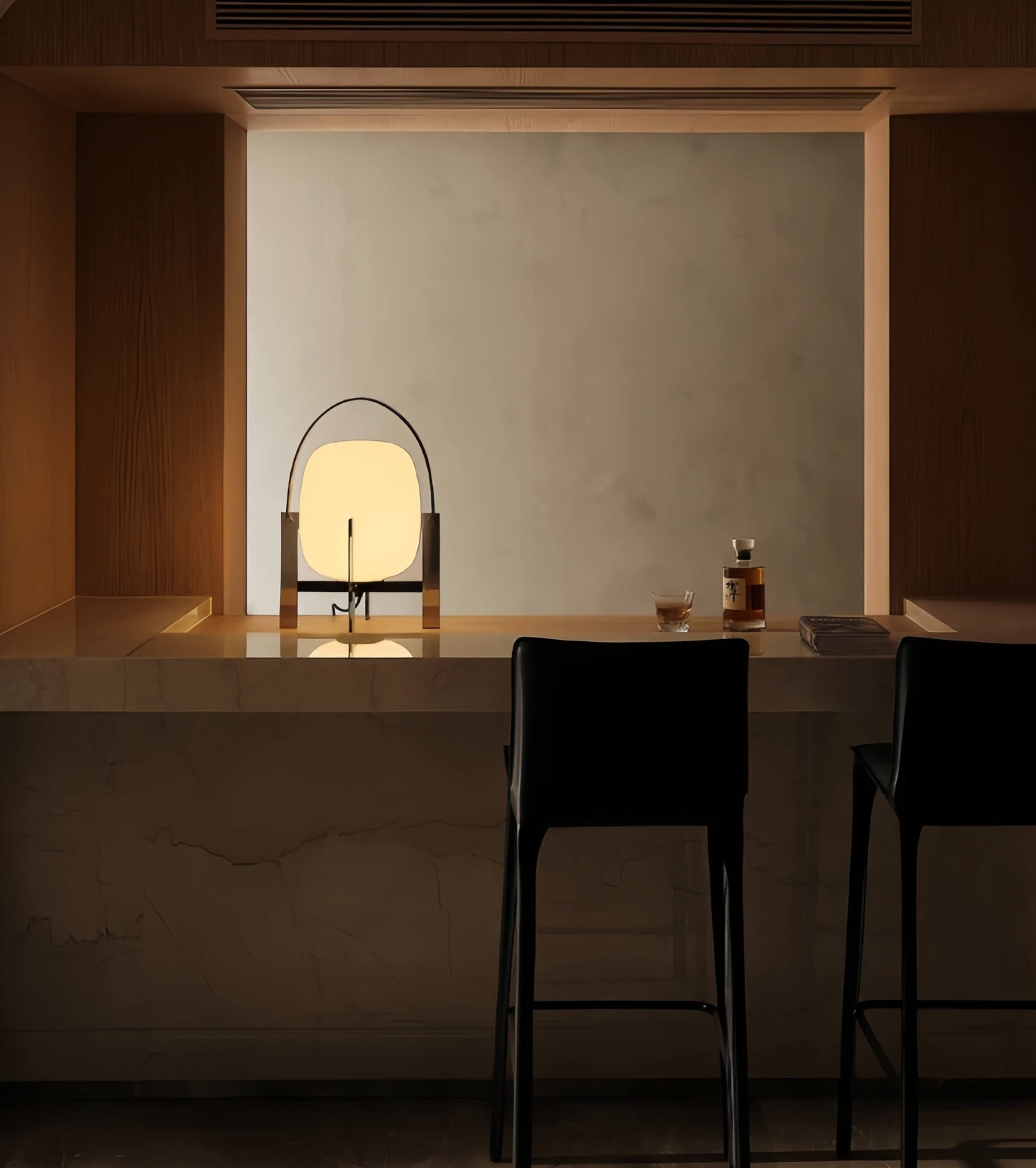 Modern interior with a table, chairs, and Alix Cesta Metálica Basket Lamp with chrome legs and frosted glass  in a dimly lit room.