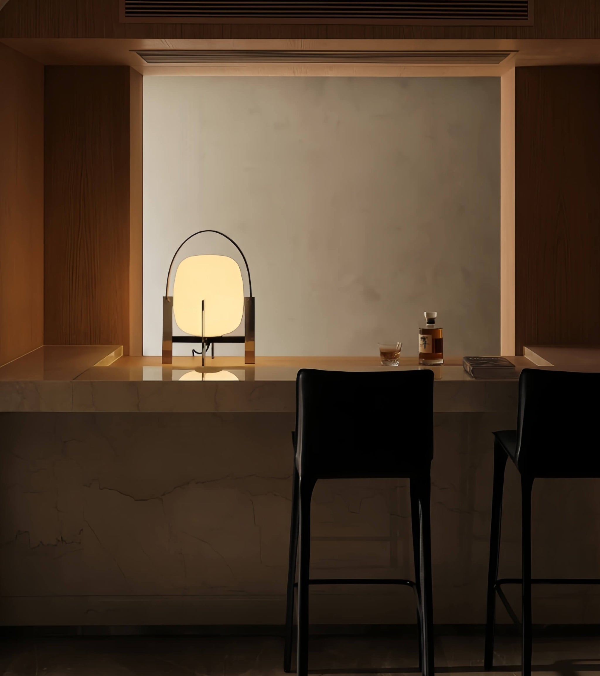 Modern interior with a table, chairs, and Alix Cesta Metálica Basket Lamp with chrome legs and frosted glass  in a dimly lit room.