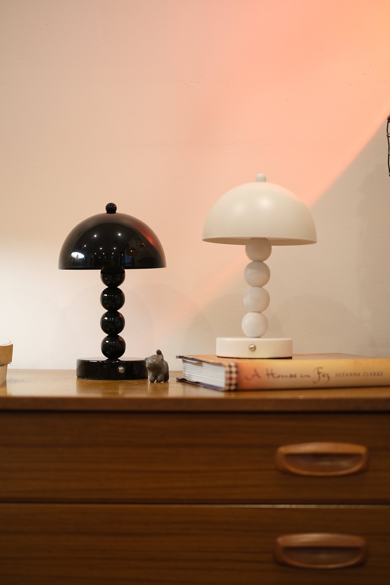 Touch dimmable Bobbi lamp in Nordic minimalist décor on a wooden surface with a warm light.