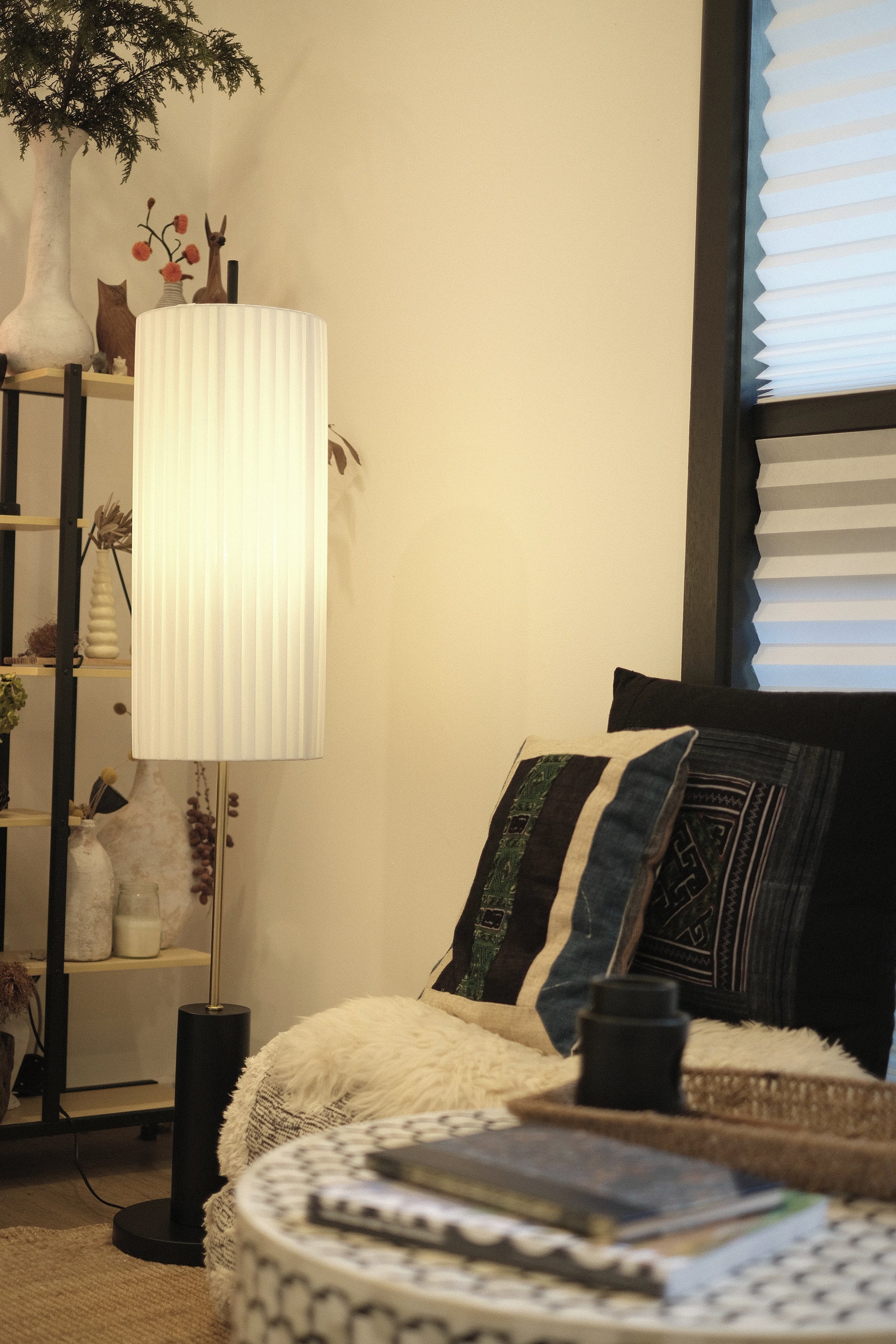 Living room with a sofa, lamp, and decorative items.