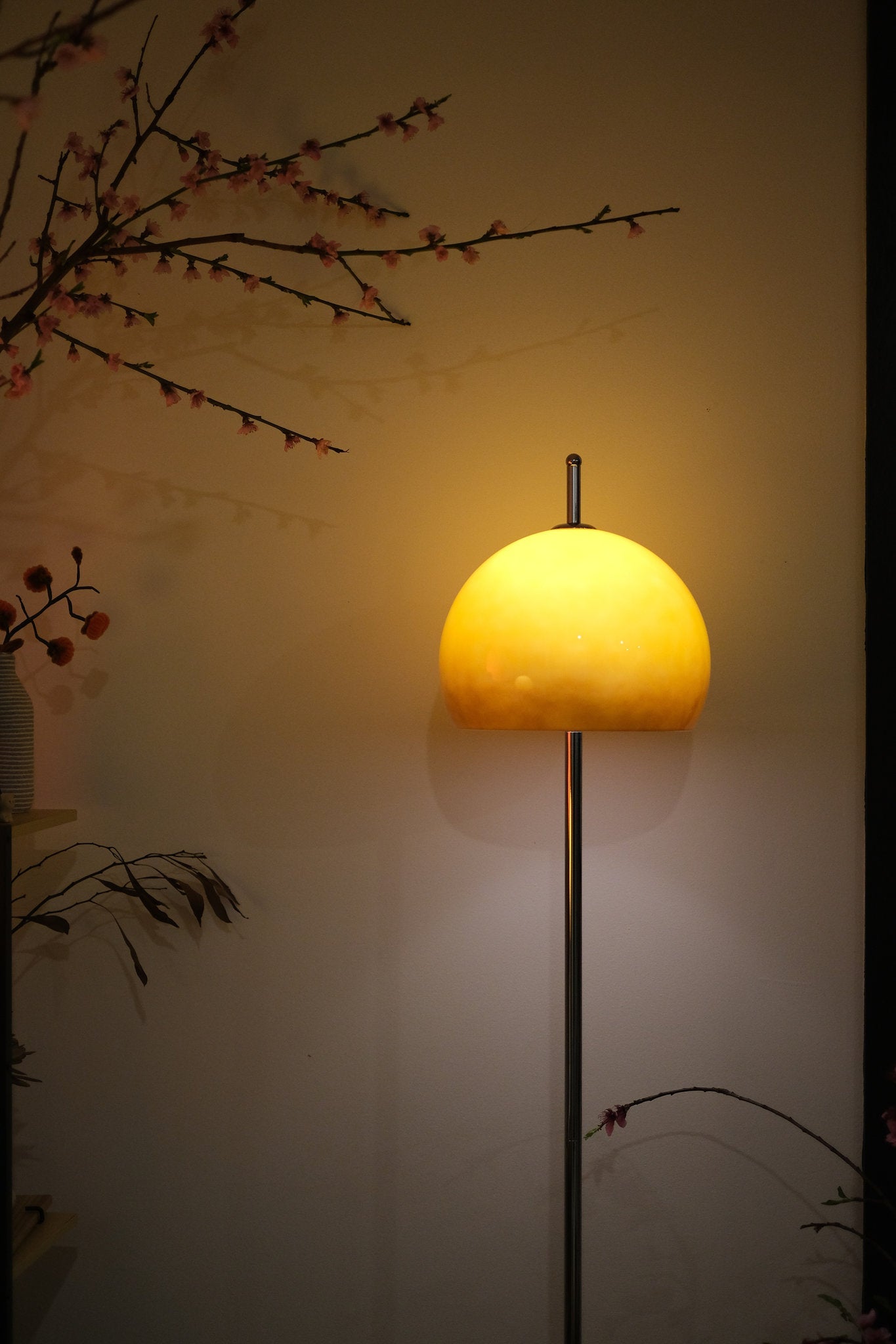 Olivia Mushroom Bauhaus Yellow floor lamp against a plain wall with minimal decorative elements