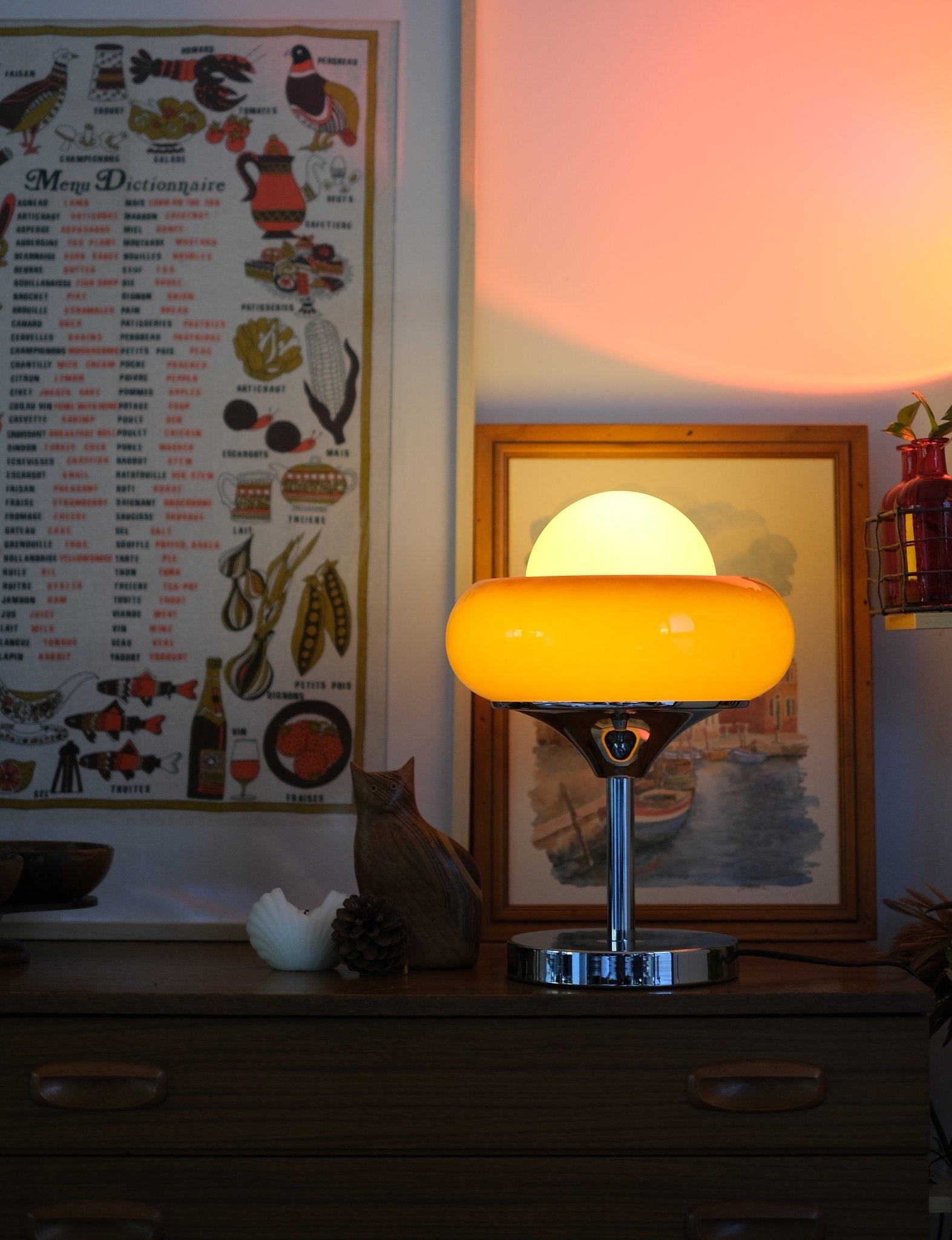 very Egg Tart retro table lamp for cozy spaces with a warm glow on a desk next to a cat and decorative items.