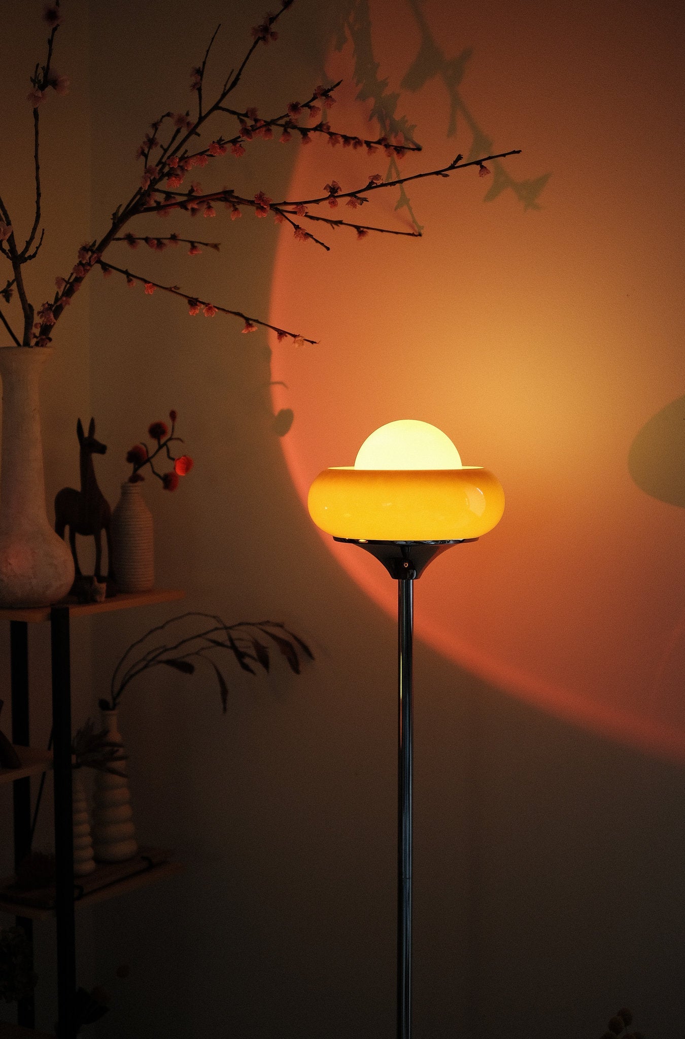70s inspired Egg Tart lamp styled as cozy corner lighting  with a warm glow in a dimly lit room