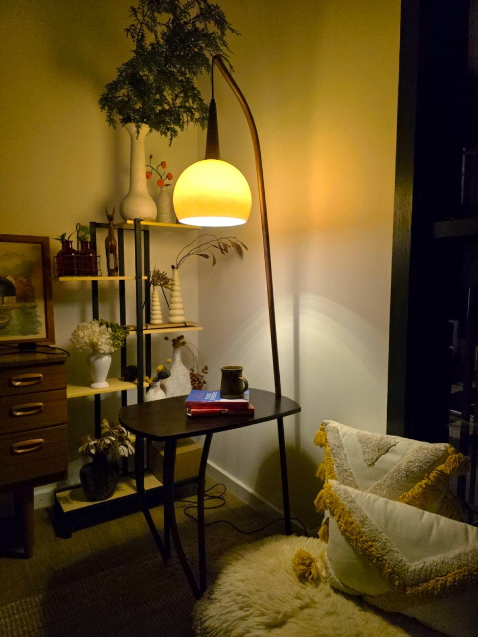 Living room with a Domus Pollo Floor Lamp with walnut stand and built-in side table and decorative items.