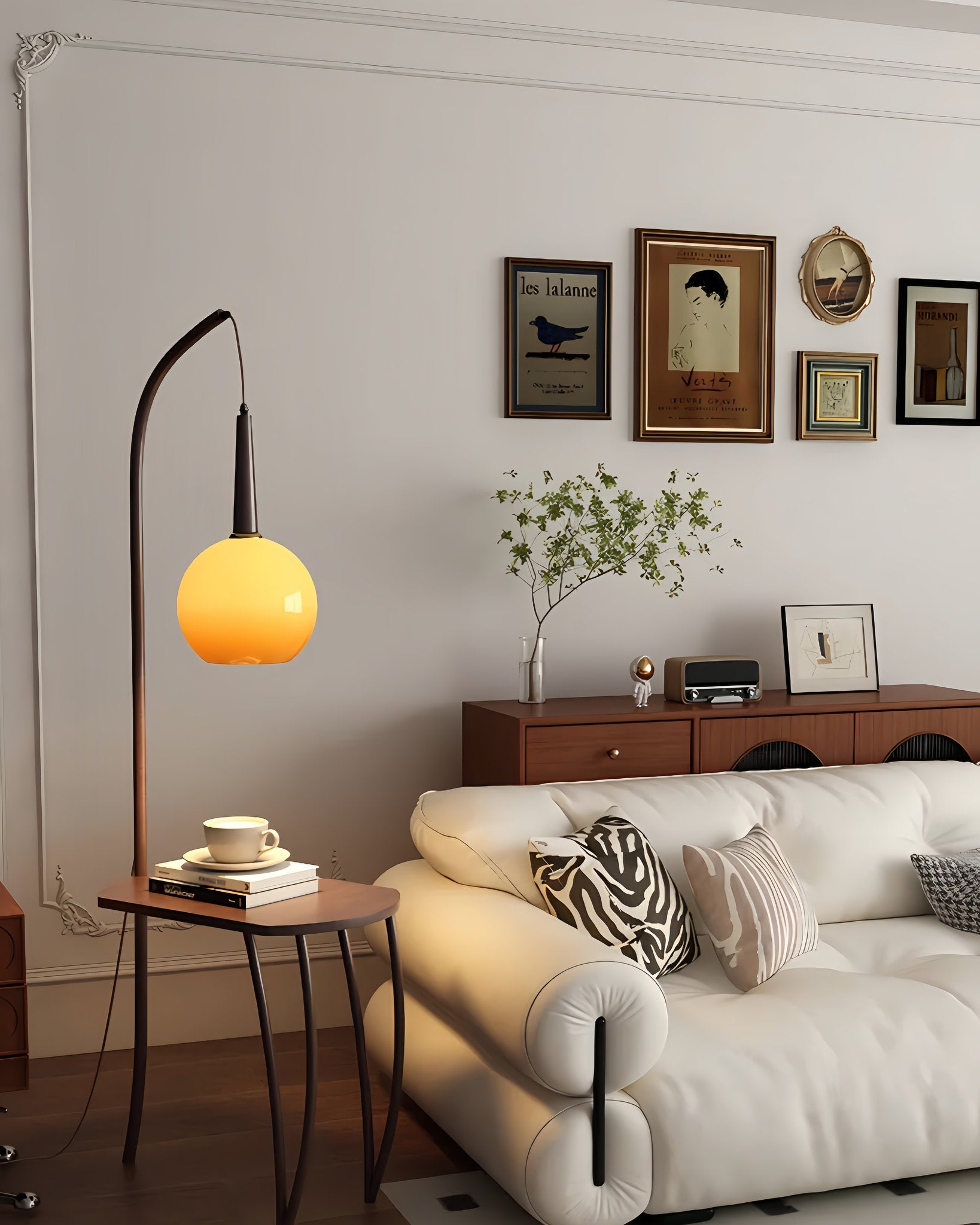 Modern living room with a white sofa, Retro floor lamp with glass shade and coffee table storage, and wall art.