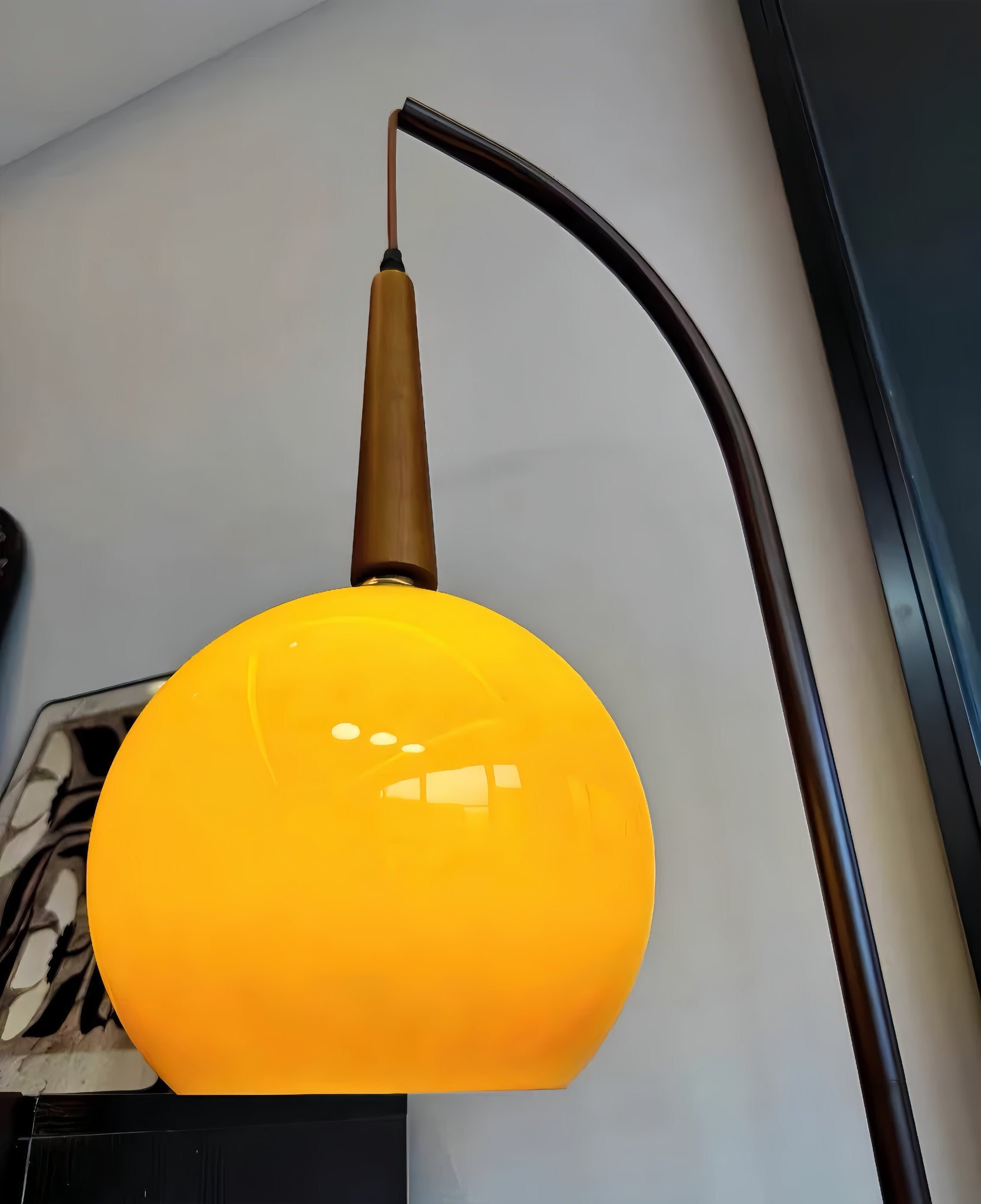 Yellow pendant light with a brown fixture against a neutral wall from Domus Pollo Floor Lamp