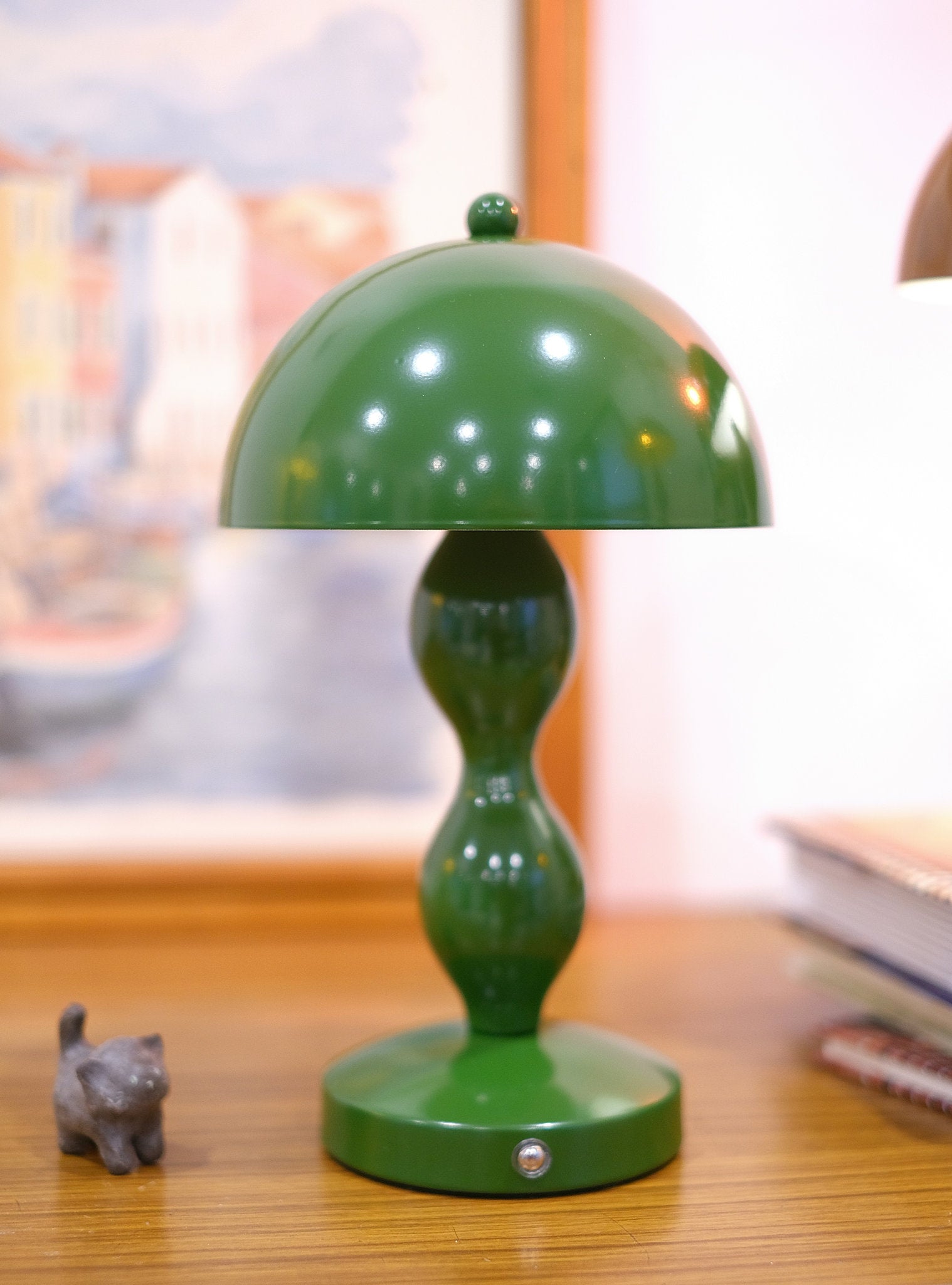 Dori LED lamp close-up showing touch switch base on a wooden surface with a blurred background