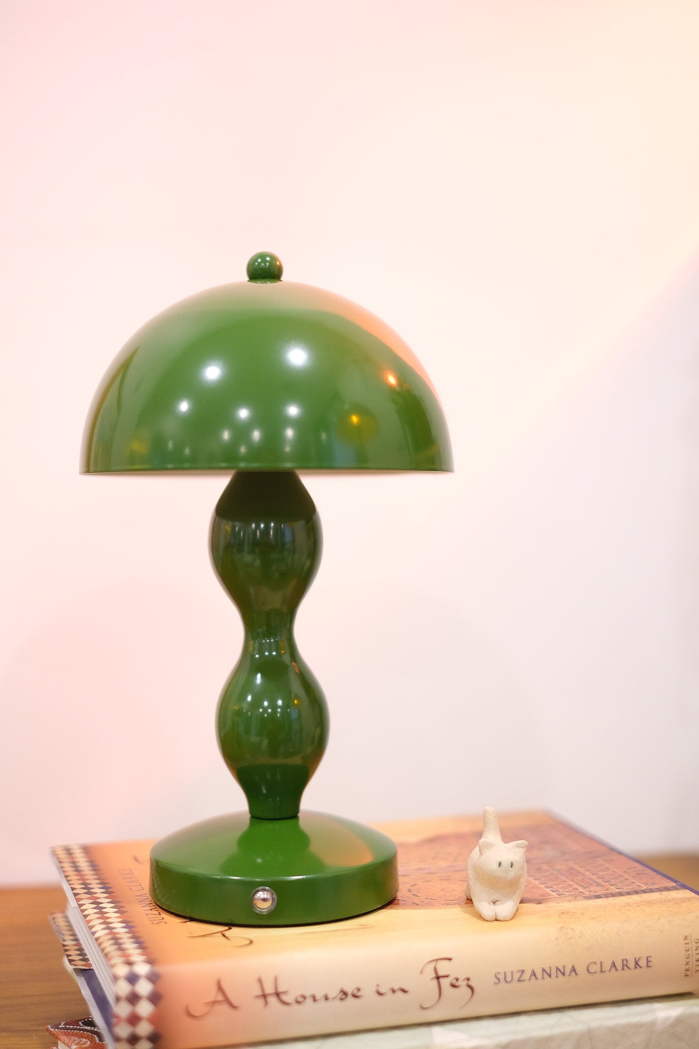 Dori LED lamp close-up showing touch switch base on a book with a white background