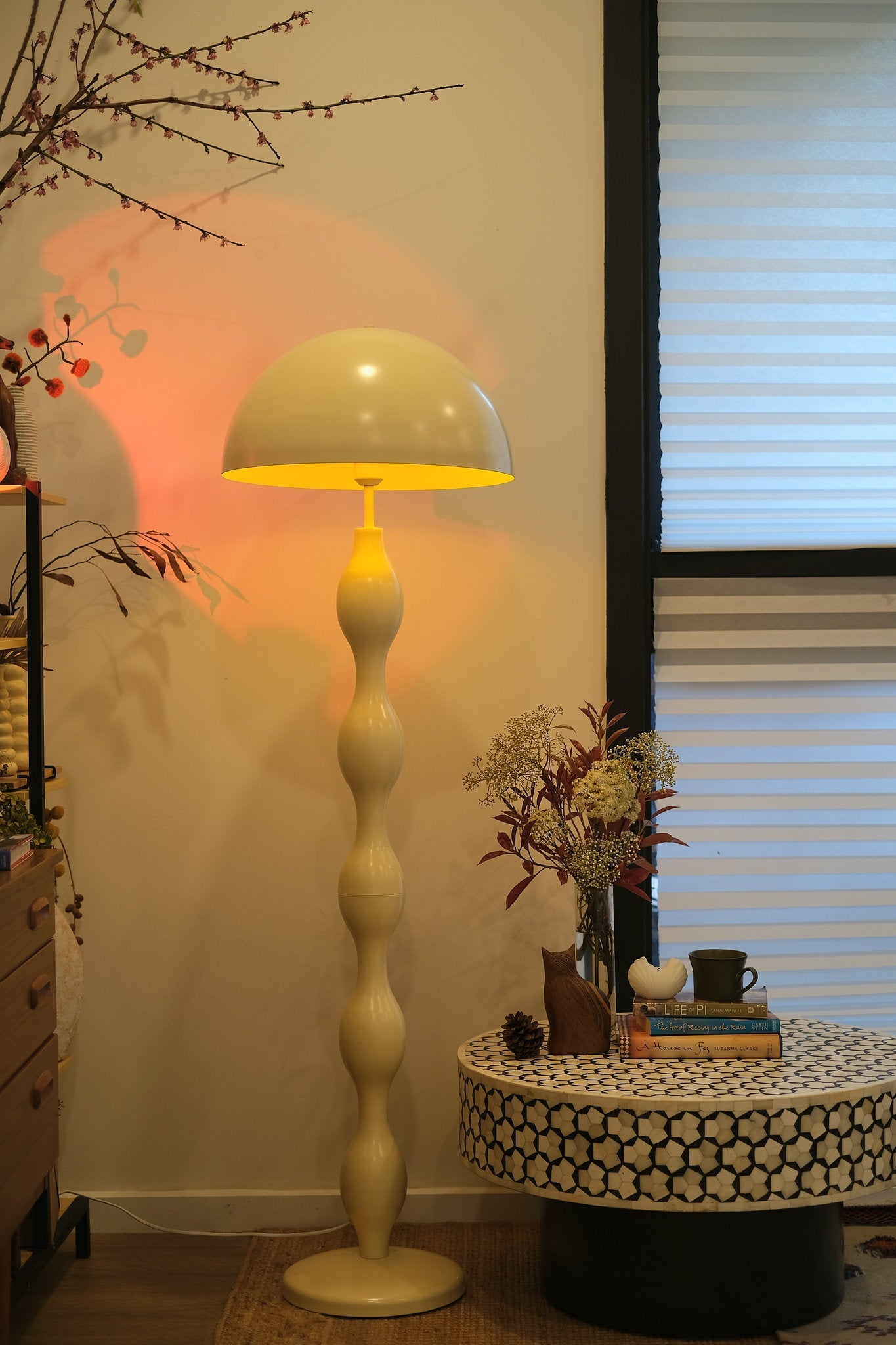 Dori Wavy Mushroom Floor Lamp in Butter Yellow casting warm ambient glow in a room setting