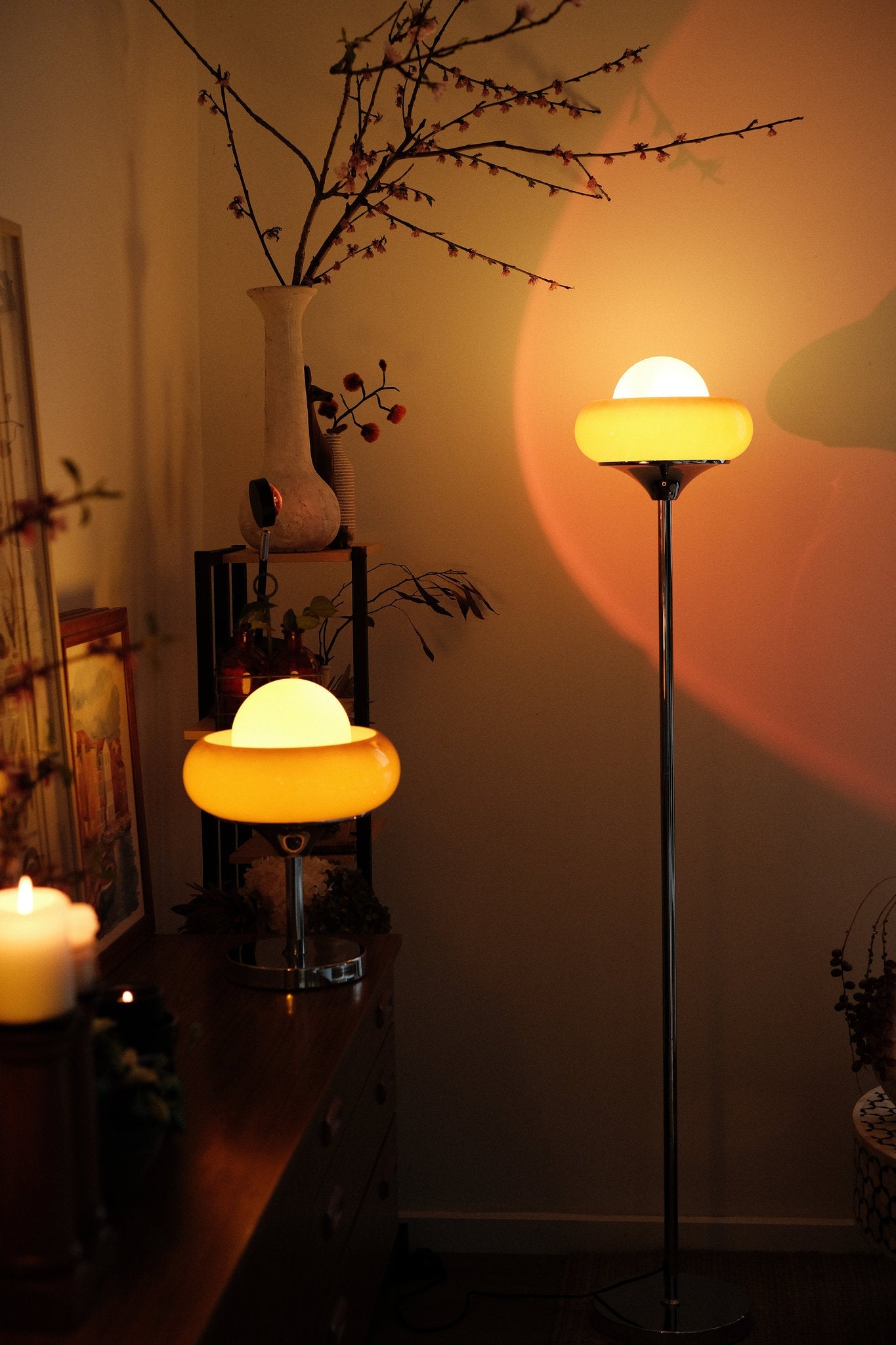 Bauhaus-inspired Egg Tart Lamp set casting soft ambient glow in living room décor with glowing yellow shades in a dimly lit room.