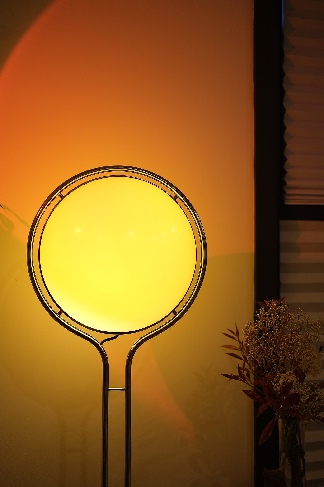 Yellow circular light fixture on a stand against an orange wall， Garreau Globe Floor Lamp Bauhaus Replica Chrome Stand