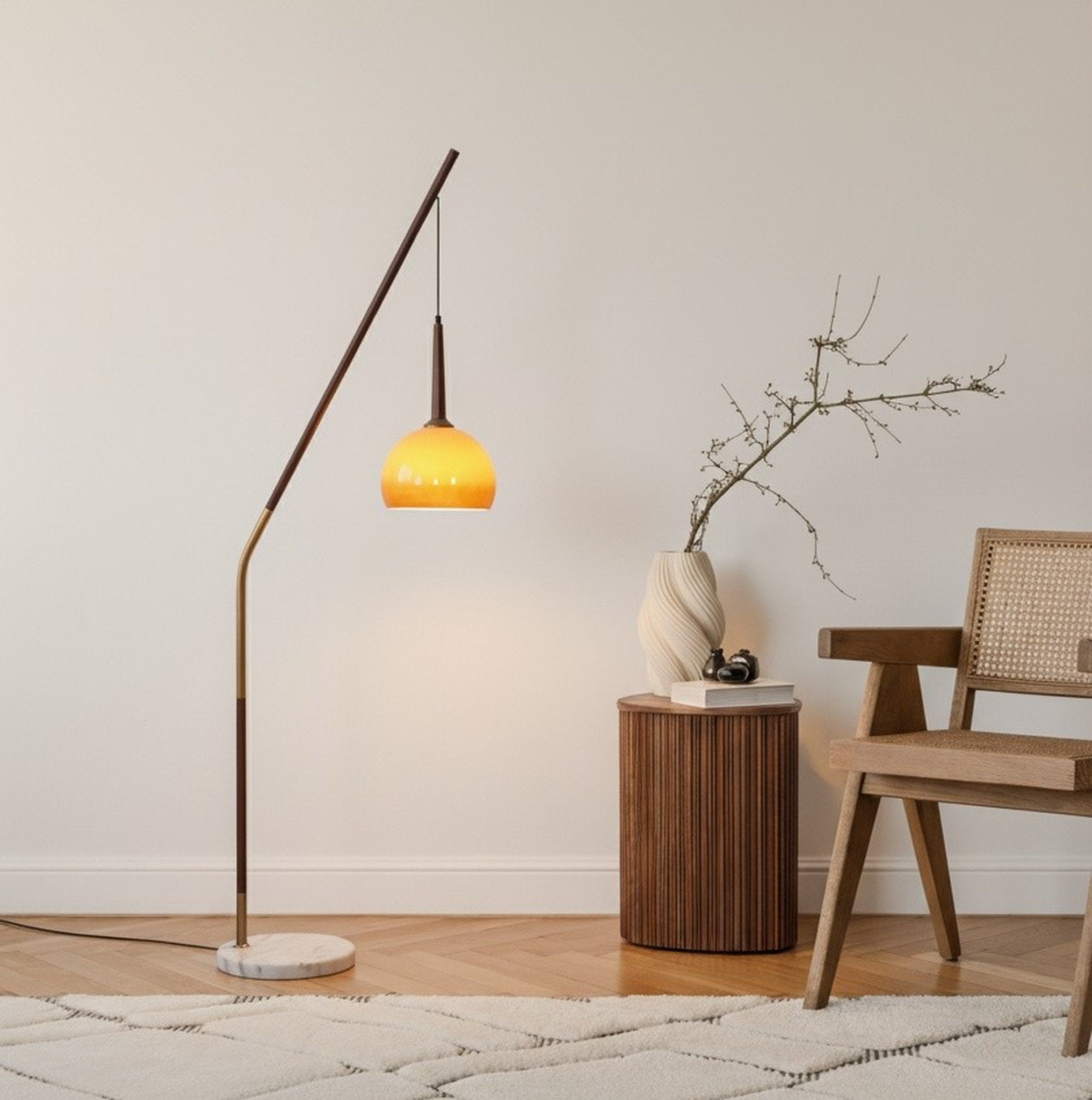 Hulusi Hanging Floor Lamp with walnut stand and gradient orange glass shade with a yellow shade in a minimalistic room.