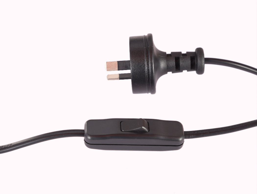 Black electrical plug with a switch on a white background