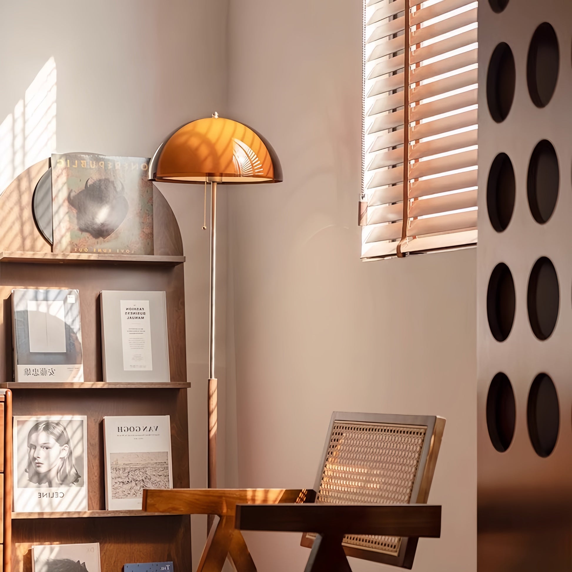 Mid century interior with a Coby+ Mushroom Bauhaus Floor Lamp Orange with Pull Chain, magazine display shelf, Wooded Chair and decorative wall art.