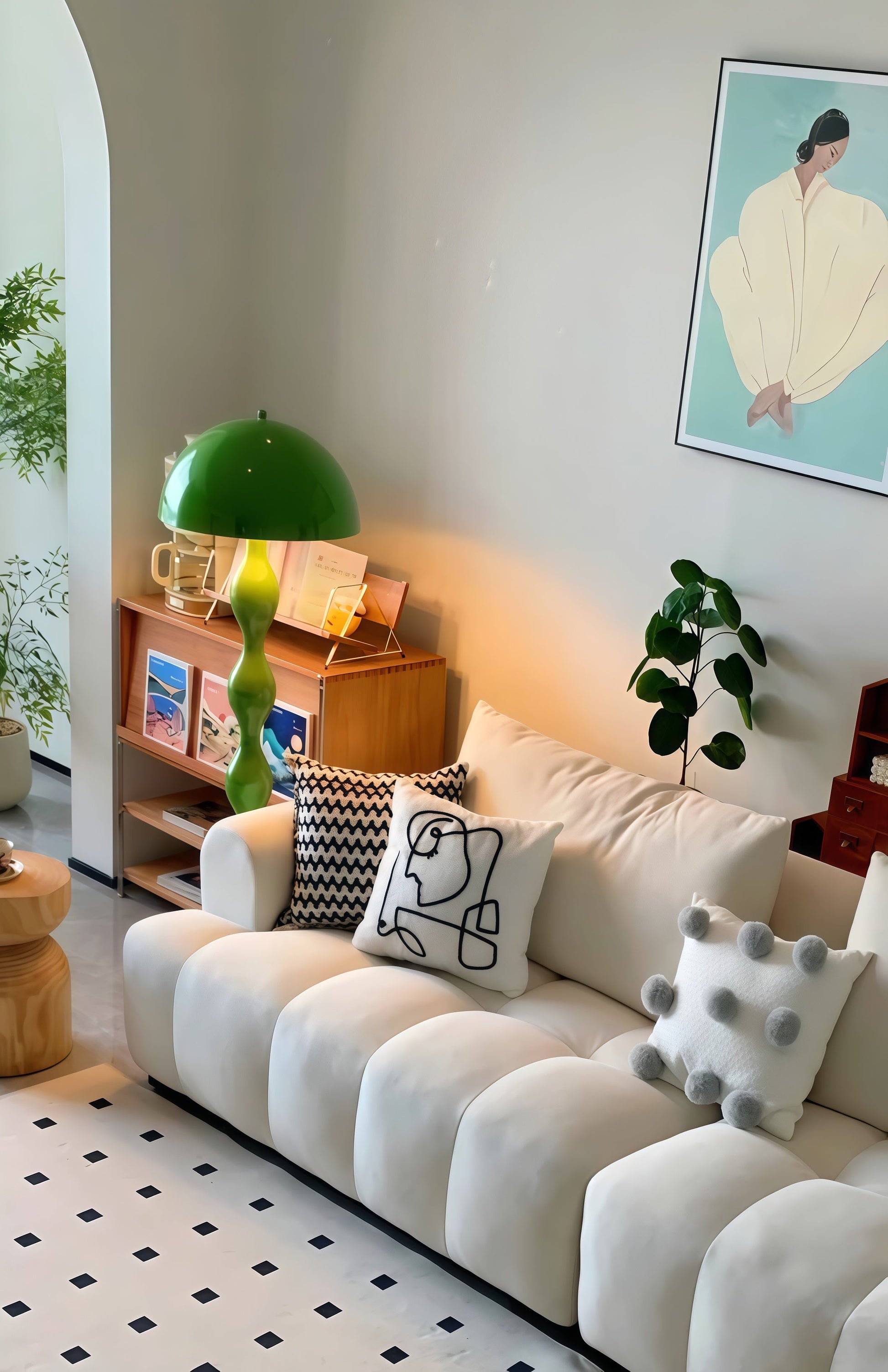Living room with a white sofa, decorative pillows, and a Dori Wavy Mushroom Floor Lamp in Olive Green with sculptural wavy base